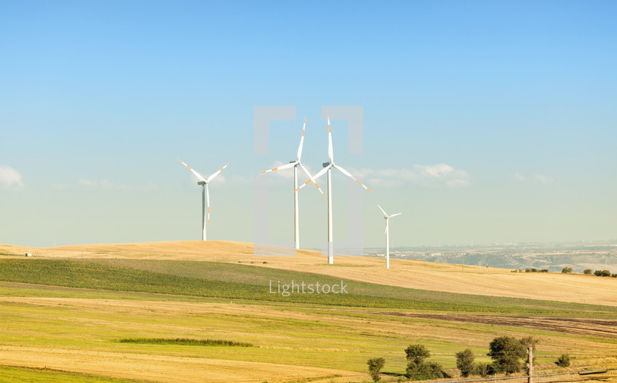 Wind turbines in operation in the summer with blue sky