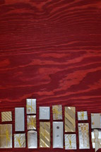 many little presents building a border on red wooden background