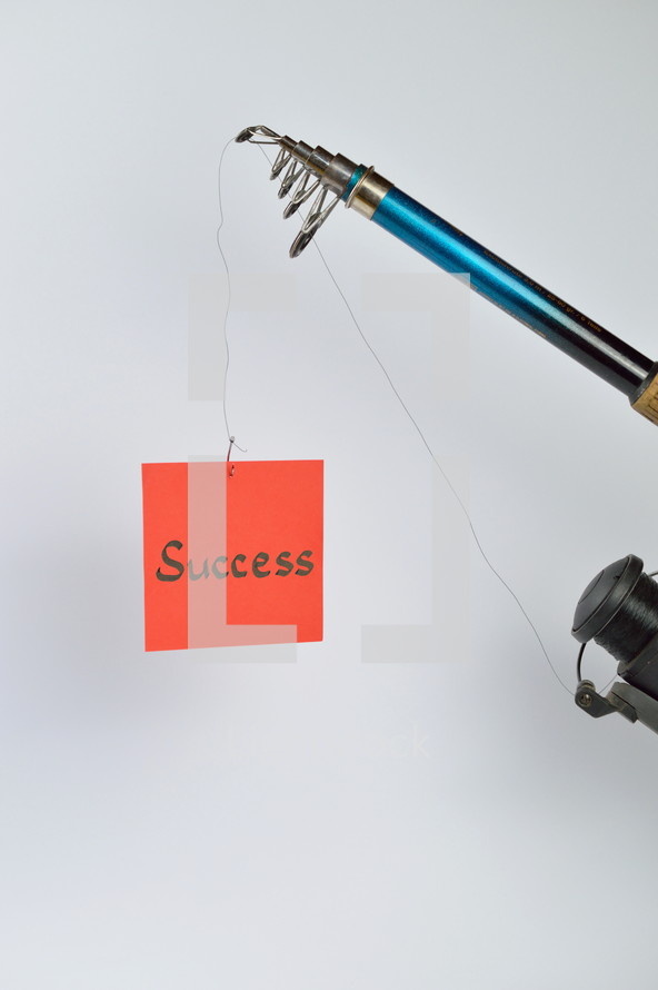 the word success on a piece of paper hanging from a fishing line 