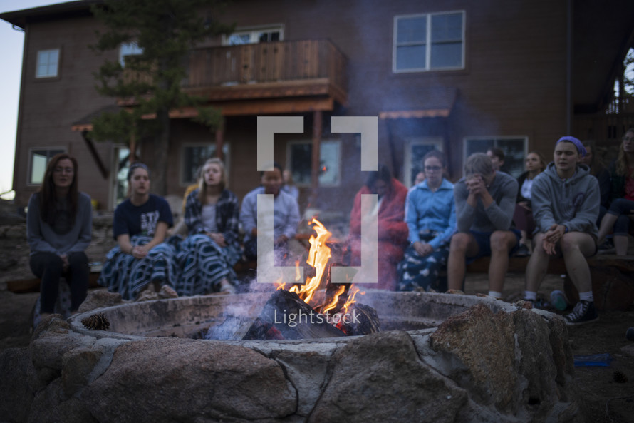 youth singing around a campfire 