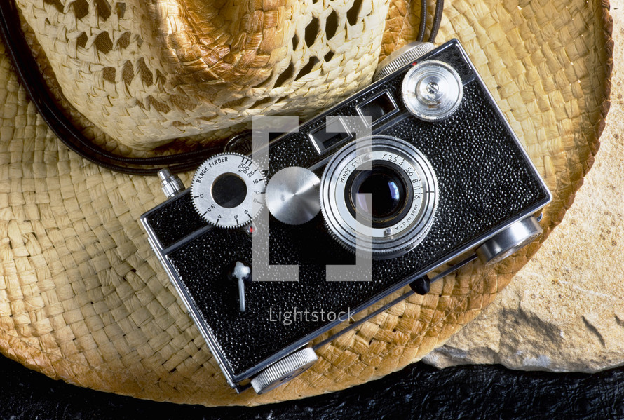 vintage camera on a straw hat 