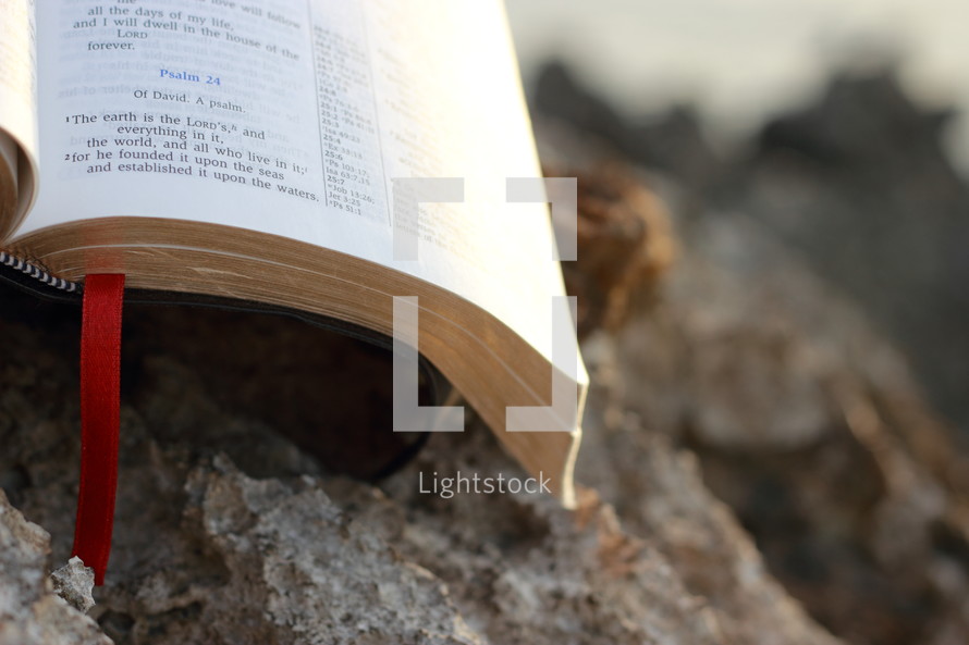 open Bible on a rock 