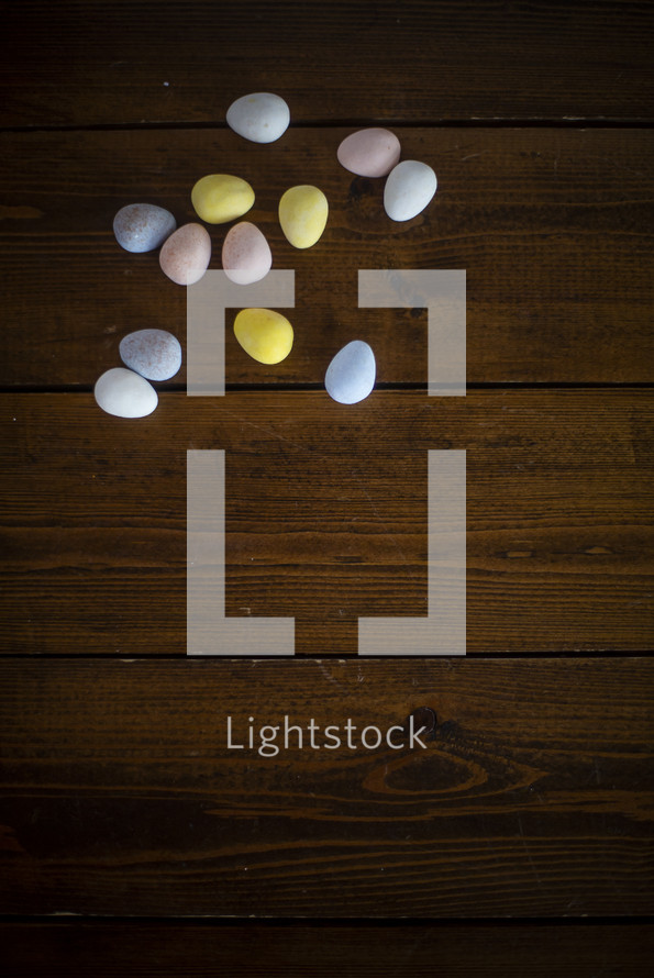 candy eggs on a wood background 