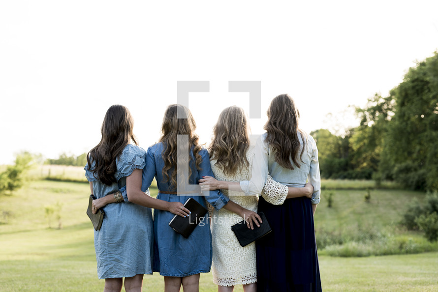 group of women holding Bibles outdoors 