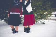 women standing outdoors in snow 