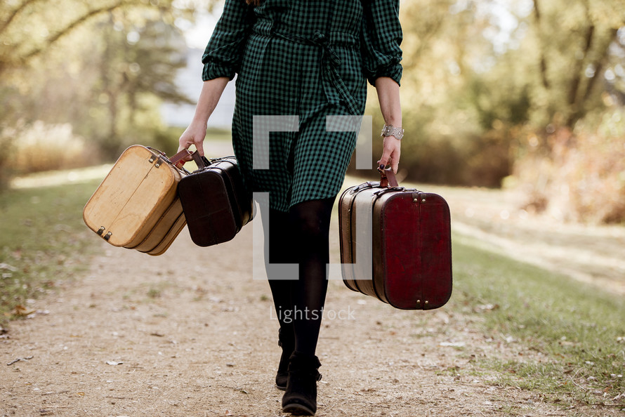 a woman walking carrying luggage 