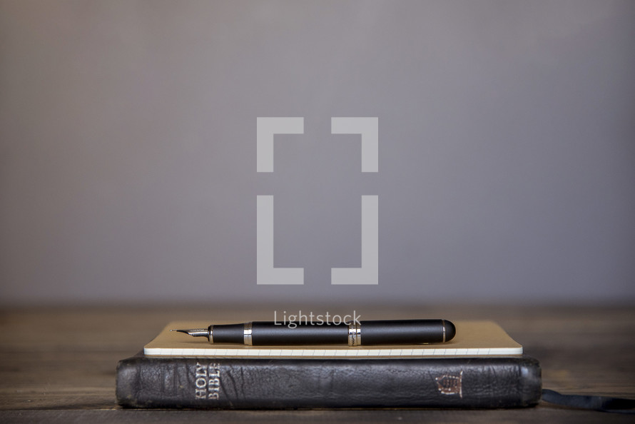 pen, journal, and Bible 