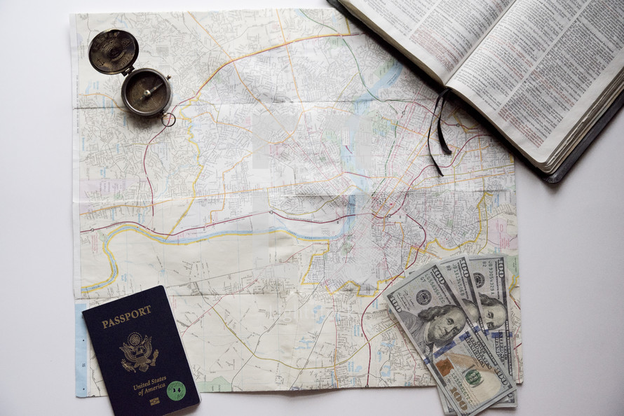 map, passport, Bible and cash on a white background 