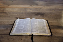 open Bible on a wood background 