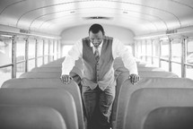A man praying on a bus 