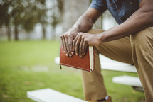 a man sitting holding a Bible 