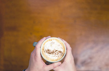 man holding a latte 