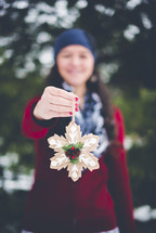 girl holding a Christmas ornament 