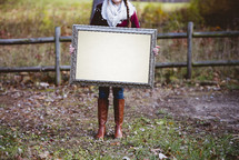 woman holding a blank sign 