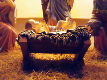 A close-up of a Manger Nativity scene focusing on the baby Jesus surrounded by Mary, Joseph and the wise men in a re-enactment of the Manger scene where Jesus was born in Bethlehem. 