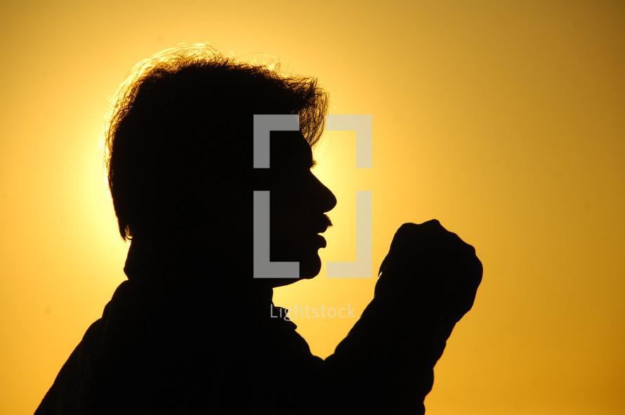silhouette of a man against a yellow sky 