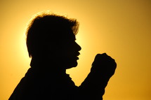 silhouette of a man against a yellow sky 