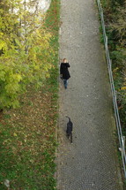 woman walking her dog on a path 