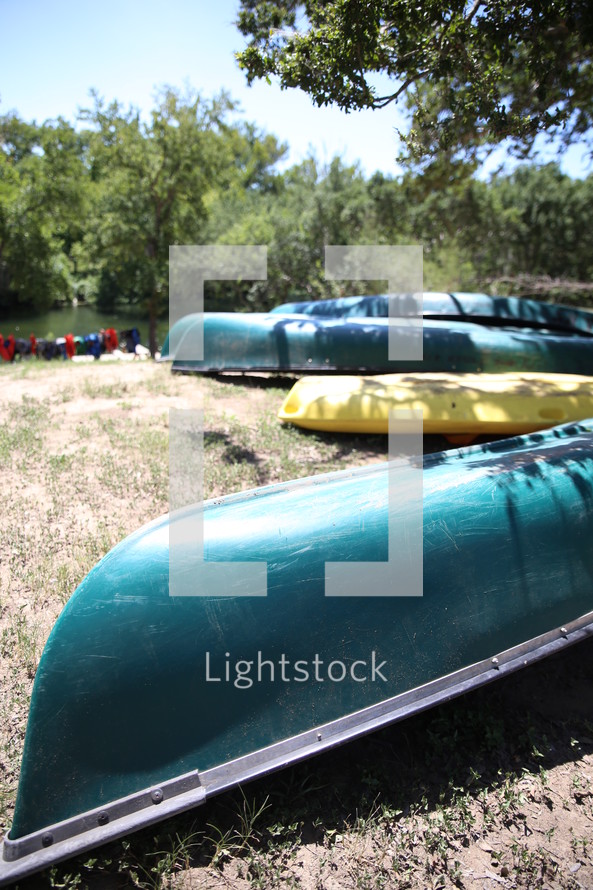 Canoes on the banks of a river.