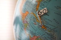 GO sign on a globe 