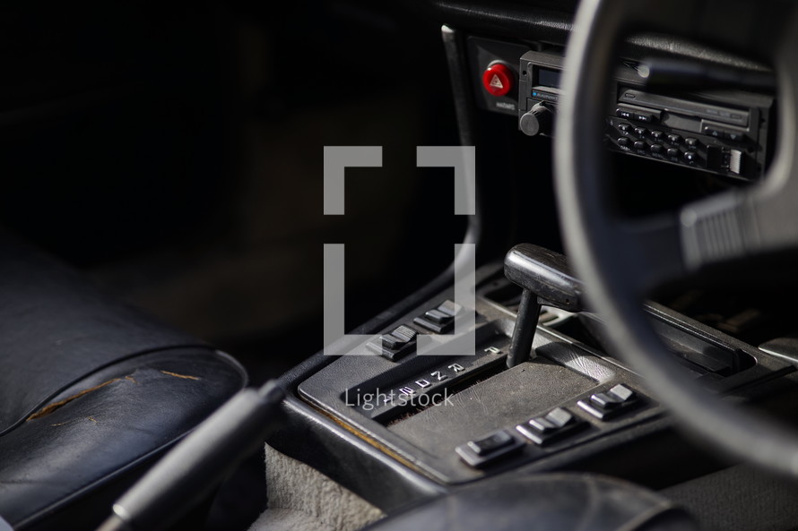 Gear shift and steering wheel inside of car