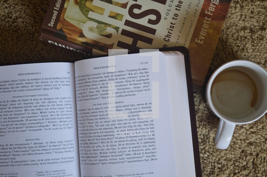 open Bible and Church history book with a coffee mug 