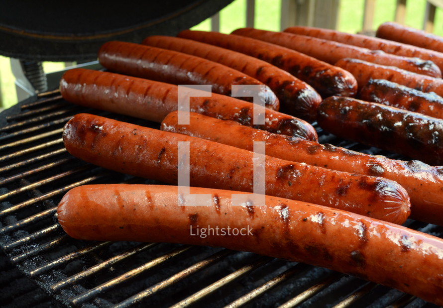 hotdogs on a grill 