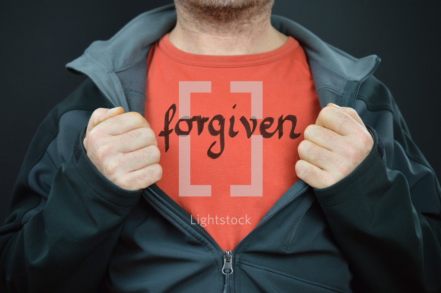a man with the word forgiven on his t-shirt 