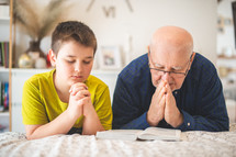 father and teenage son praying