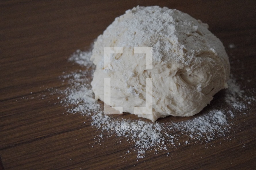 Making bread - dough and flour on table