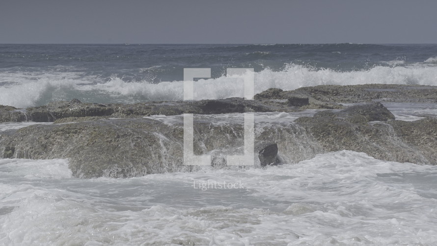 Crashing ocean waves on a rocky shore.