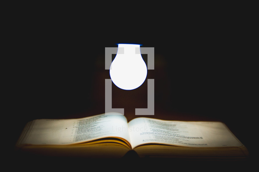 glowing lightbulb over the pages of a Bible 