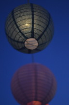 Paper lanterns floating in the sky.