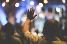 hands raised at a contemporary worship service 