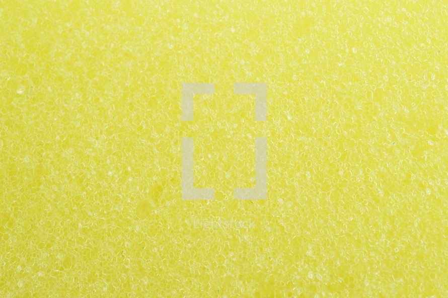 close-up of yellow sponge surface as texture background