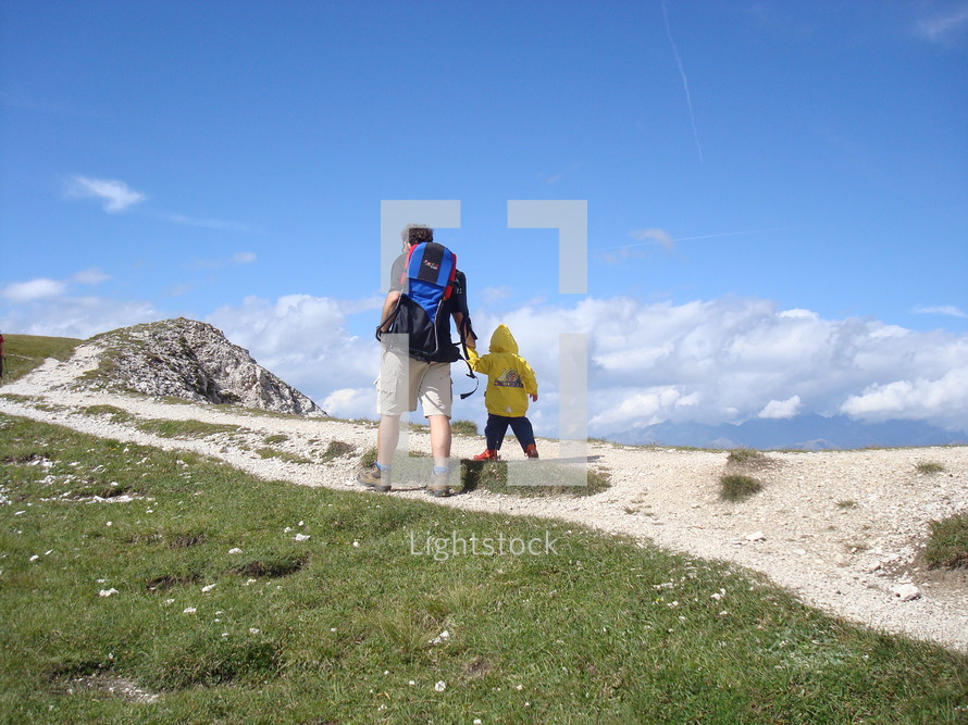 father and son hiking, 
father, son, mountain, hiking, man, child, boy, nature, activ, activity, backpack, hill, leading, hand in hand, safe, secure, father's day