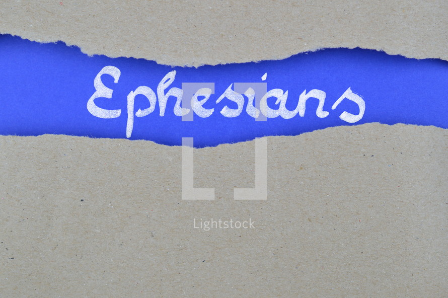 word Esphessians exposed under gray torn paper 