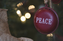 peace Christmas ornament on a Christmas tree
