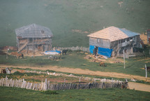 Wooden fence and houses in the summer mountains