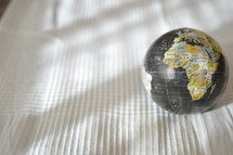 globe on a white table cloth