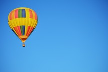 rainbow hot air balloon against blue sky 