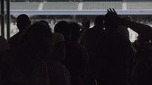 silhouettes of people in a stadium 