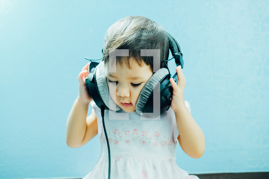 infant girl listening to headphones 