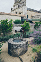gardens and well in front of a cathedral in France 