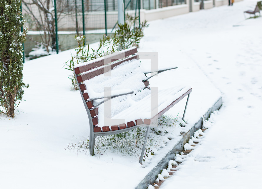 bench covered in snow 