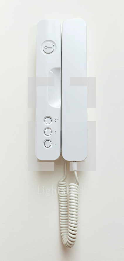 Phone observation system on white wall.