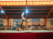 wrestlers wrestling in a wrestling ring 