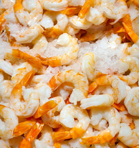 Fresh peeled shrimp on ice for sale at market