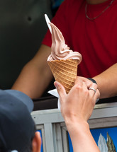 Selling ice cream with typical ice cream truck, detail of the hand of the customer while taking the ice cream