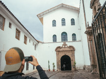 tourist taking a picture of a building 